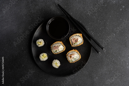 Fried sushi and avocako maki on the plate