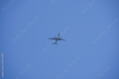 Shot of a jet plane high in the blue skies.