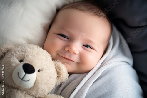 happy baby with teddy bear smiling