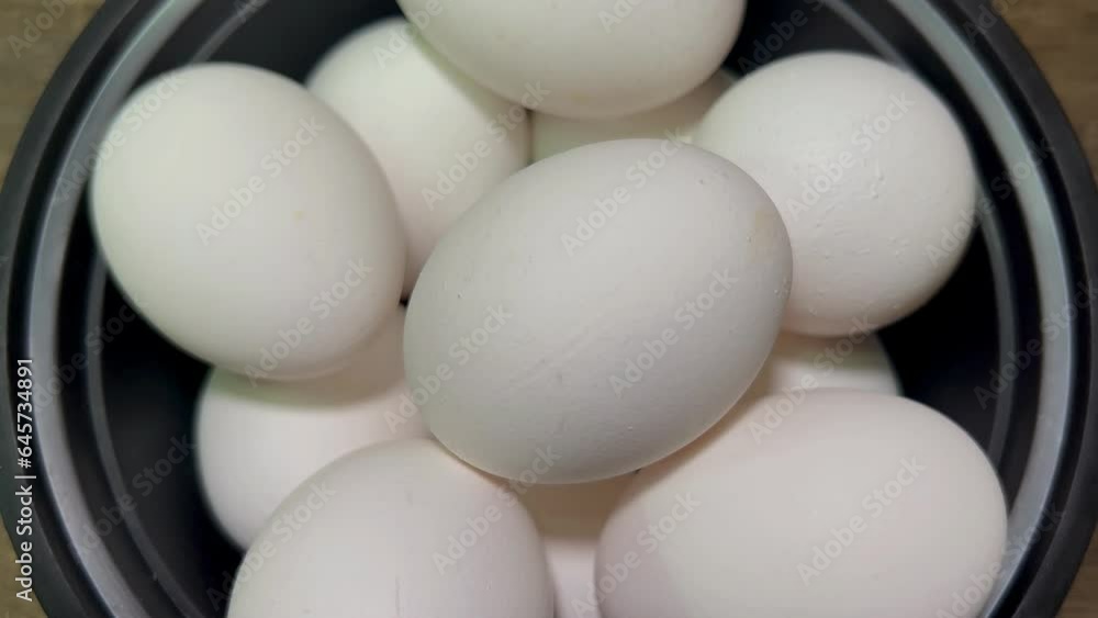 Many fresh raw chicken egg under to white bol Many fresh raw chicken egg under to white bol