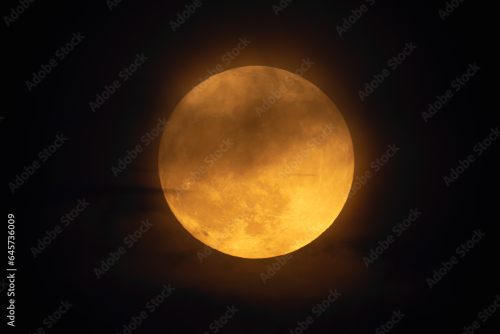 Moon looks orange and you can see the craters. Photography taken with a telescope. Moon looks orange and you can see the craters. Photography taken with a telescope.