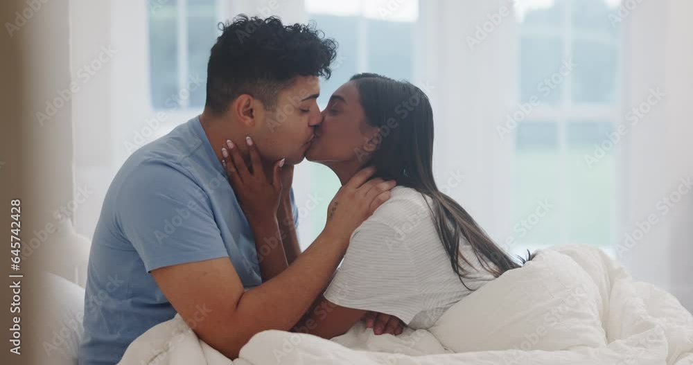 Man, woman and kiss in bedroom for love, care or intimate moment in relationship together at home. Couple, partner and kissing in bed for romance, happy morning or enjoy anniversary on valentines day Man, woman and kiss in bedroom for love, care or intimate moment in relationship together at home. Couple, partner and kissing in bed for romance, happy morning or enjoy anniversary on valentines day