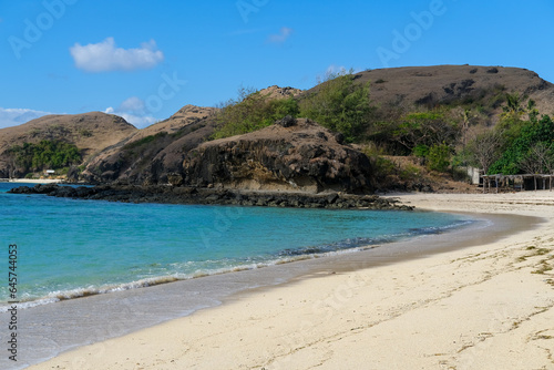 Fototapeta Naklejka Na Ścianę i Meble -  Kuta beach Lombok. Kuta Lombok is a small spread-out town in a beautiful bay lined by a long white sand beach, a beach with blue sky, a beach with sky and white sand, view of the beach in island