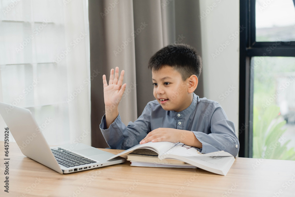 Little Asian boy student using computer laptop learning. Educational concept Social distancing, staying at home, presenting a modern educational way of life. Little Asian boy student using computer laptop learning. Educational concept Social distancing, staying at home, presenting a modern educational way of life.