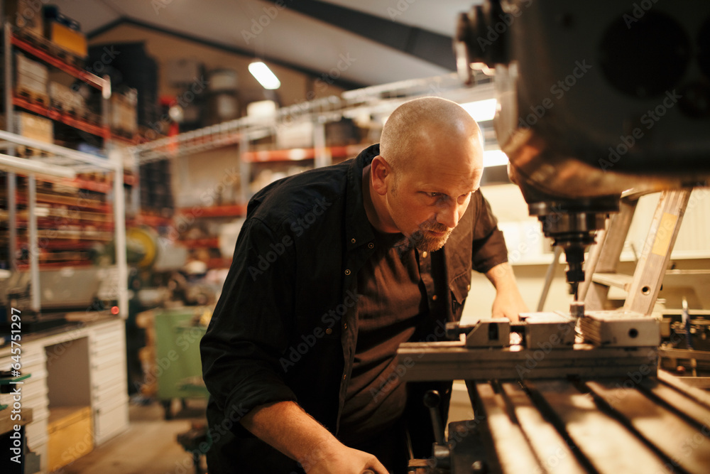 Middle aged man working in a factory