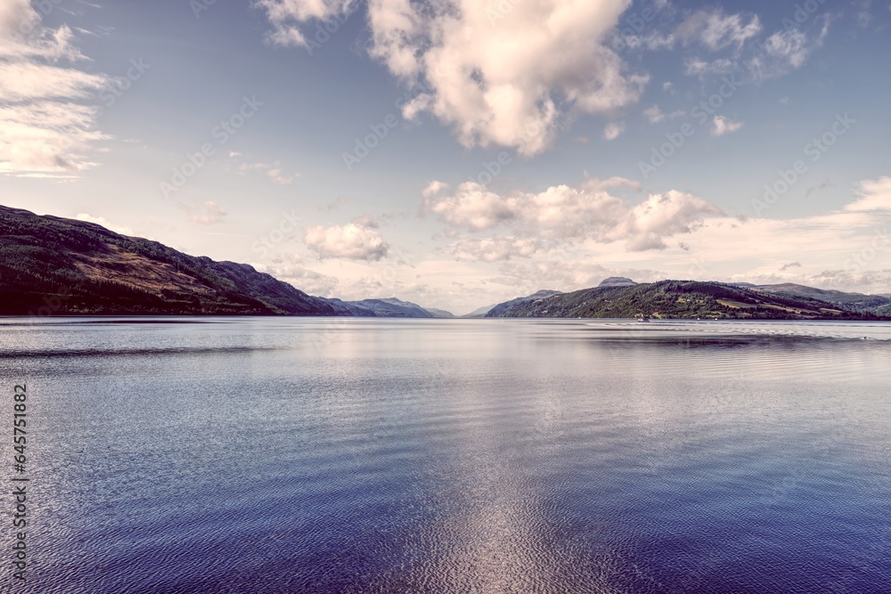 Vivid Depth: Textured Loch Ness Waters with Hills and Boat in the Background