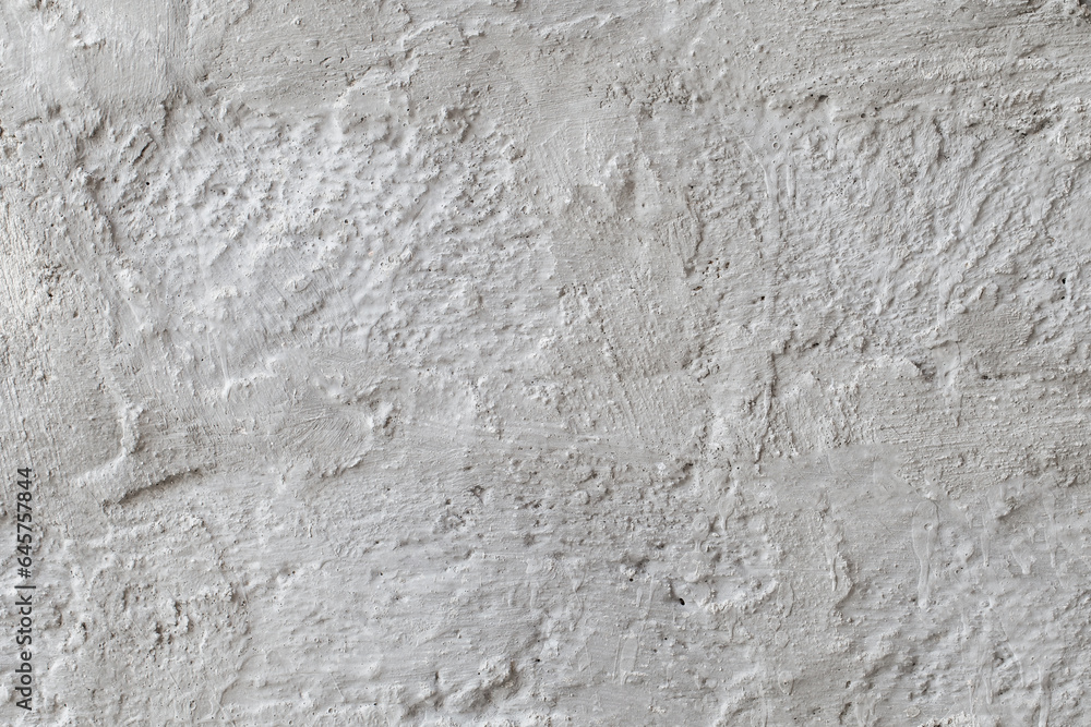 Rough plastered coarse light wall with divorces close-up, uniform texture background