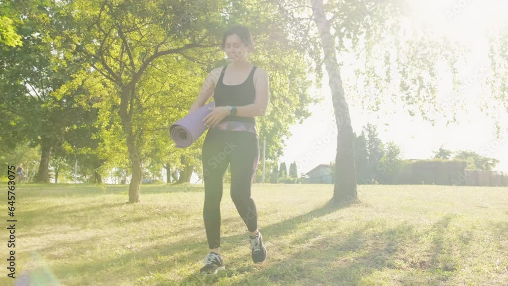 Fitness girl with a map for yoga preparing to practice yoga, outdoor recreation and workout exercises Fitness girl with a map for yoga preparing to practice yoga, outdoor recreation and workout exercises