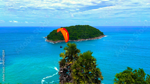 Parra  Glider at Ya Nui Beach and Nai Harn Beach in Phuket Thailand, turquoise blue waters, lush green mountains colourful skies. Phuket is a tropical island  photo