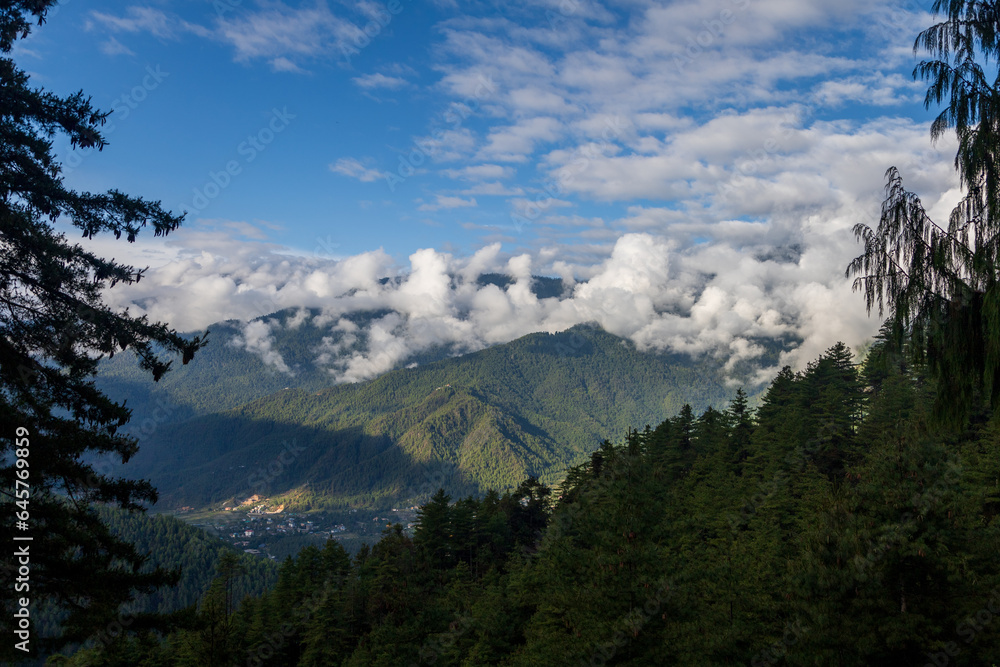 Beautiful view of a valley with trees and mountains in Bhutan, scenic panorama mountain summer landscape