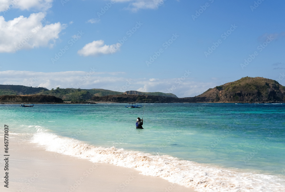 fishing on the beach, fisherman on the beach, traditional angler, local residents fishing on Lombok beach, tanjung aan beach lombok, fishing on the beach on a sunny day