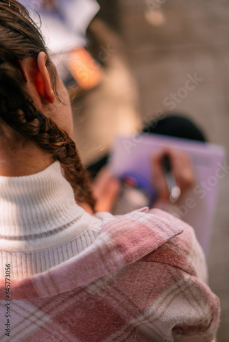 Girl doing homework. Above view shot. Close up