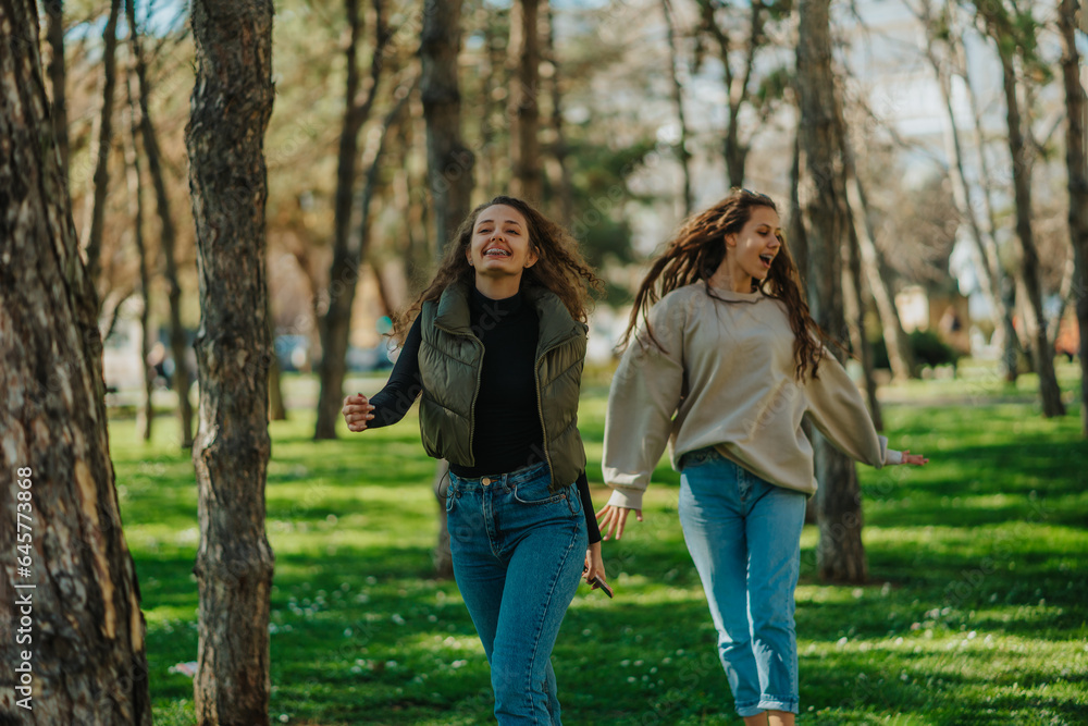 Girls dancing and singing while walking in the park