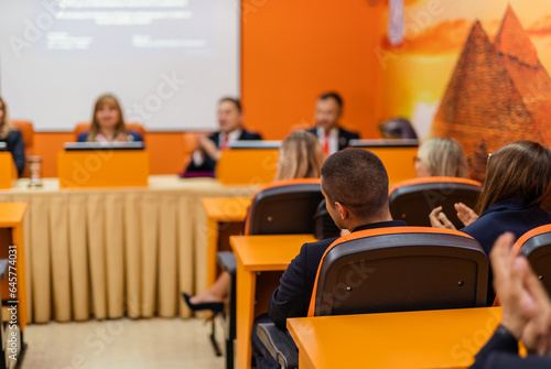 Professors and students applauding a student
