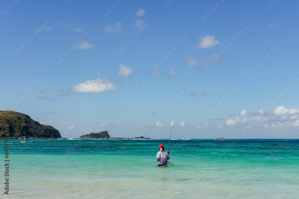 fishing on the beach, fisherman on the beach, traditional angler, local residents fishing on Lombok beach, tanjung aan beach lombok, fishing on the beach on a sunny day fishing on the beach, fisherman on the beach, traditional angler, local residents fishing on Lombok beach, tanjung aan beach lombok, fishing on the beach on a sunny day