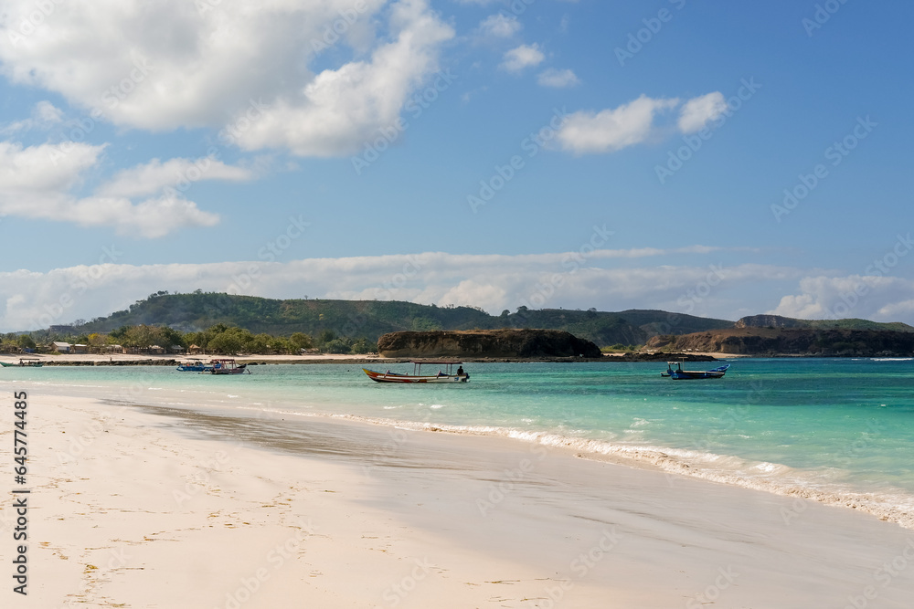 The most beautiful beach in Lombok and the closest to Kuta is Tanjung Aan Beach, A Hidden Gem Waiting for You to Explore on Lombok. beautiful beach surrounded by hills and blue sea