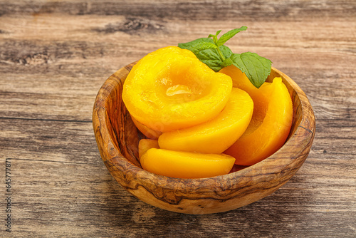 Sweet ripe canned peaches with mint