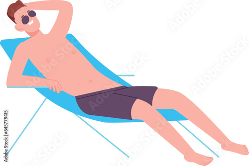 Relaxing young man sit in deckchair. Sunbathing on beach
