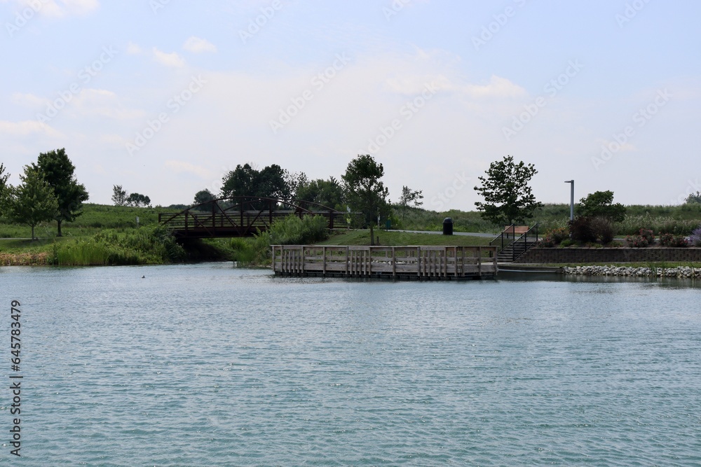 The wood fishing dock at the lake on a sunny day. The wood fishing dock at the lake on a sunny day.