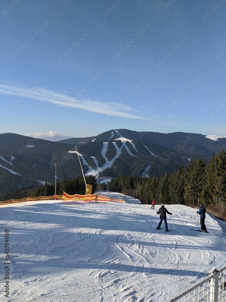 Discover the tranquil beauty of alpine landscapes with well-preserved ski runs, snow-covered trails, and evergreen forests set against the backdrop of majestic mountains  🏂🌲.