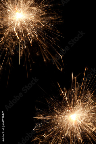 Burning sparklers on black background