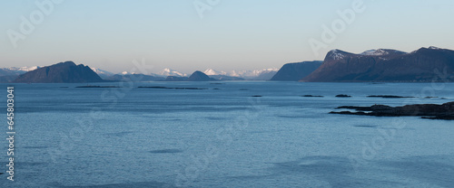 Norwegian landcapes with snowy mountains photo