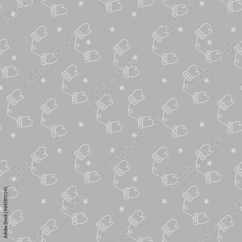 Seamless pattern of winter warm gloves on a gray background