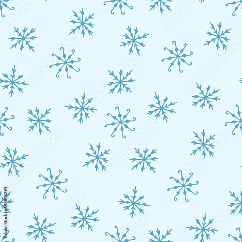 Seamless pattern of winter snowflakes on a blue background