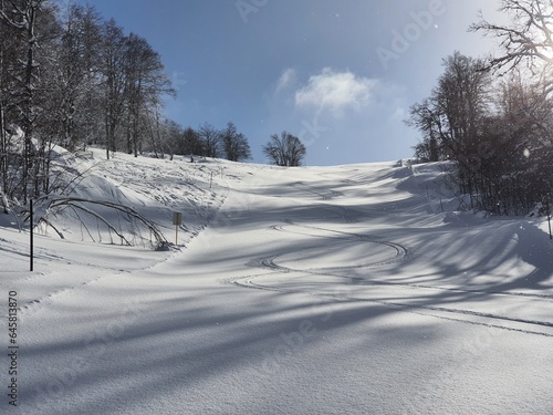 Skiing turns traces on fresh snow. Winter landscape.