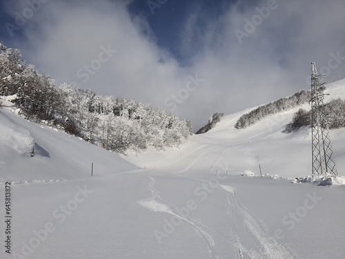 Skiing turns traces on fresh snow. Winter landscape. © Eyo