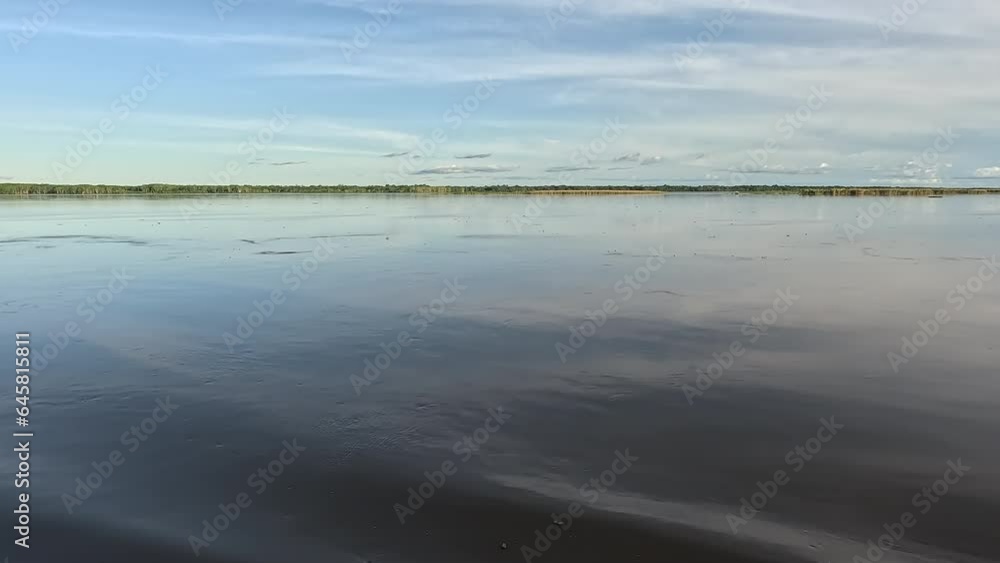 The calm wide expanse of the Amazon River in Peru during sunset The calm wide expanse of the Amazon River in Peru during sunset