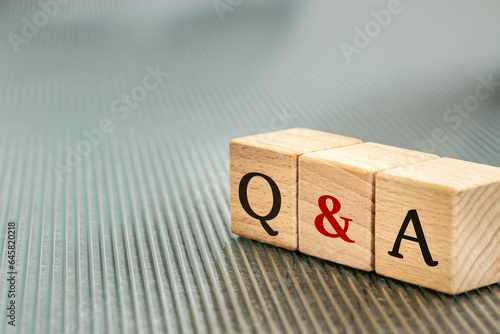 Q and A, Questions & Answers symbol written on wooden blocks, business concept, copy space