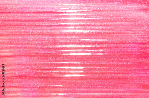 Pink shimmering lip gloss texture background with highlights. Smudged cosmetic product smear. Makup swatch product sample