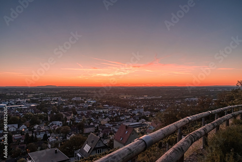 sunset over a small town and the view from the nearby hill 