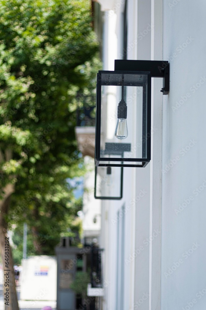 Modern squared black outdoor lamp in a modern street in Athens Modern squared black outdoor lamp in a modern street in Athens