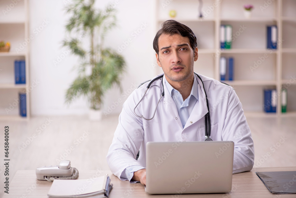 Young male doctor in telemedicine concept Young male doctor in telemedicine concept