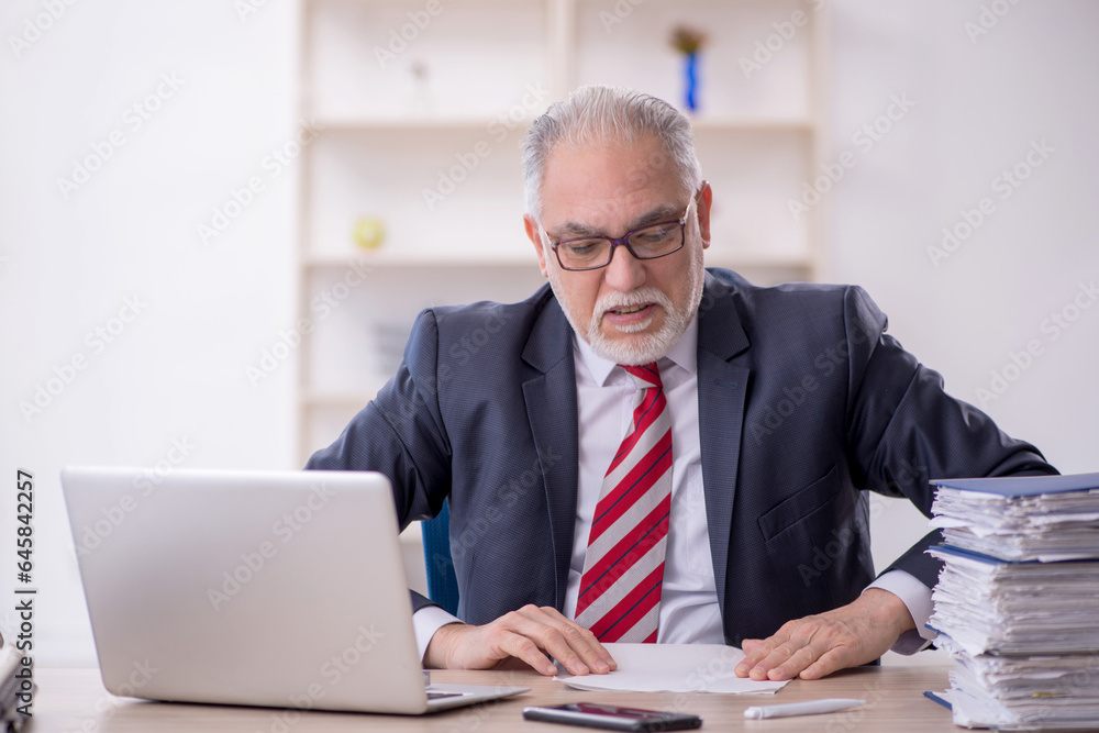 Old male employee and too much work in the office Old male employee and too much work in the office
