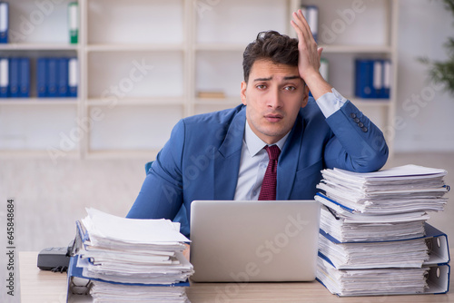 Young male employee working in the office