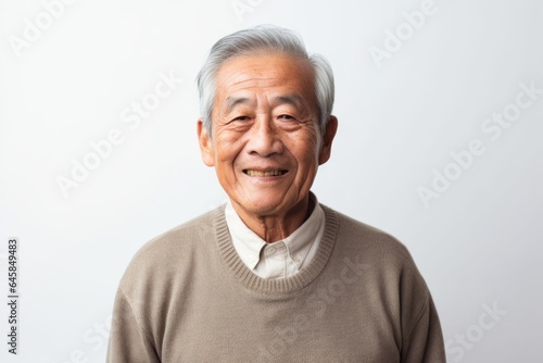 Medium shot portrait photography of a Vietnamese man in his 80s against a white background