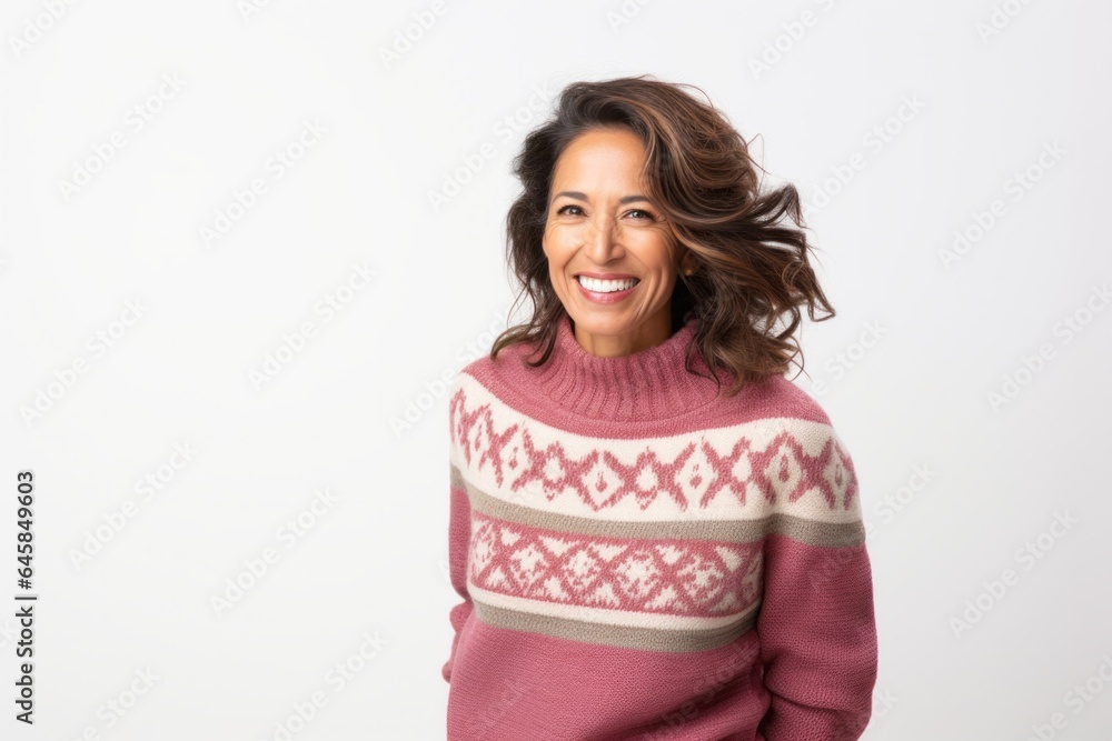 Lifestyle portrait photography of a Peruvian woman in her 50s wearing a cozy sweater against a white background Lifestyle portrait photography of a Peruvian woman in her 50s wearing a cozy sweater against a white background