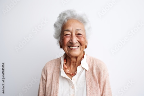 Medium shot portrait photography of a Peruvian woman in her 90s against a white background