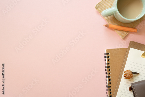 Notebook, clipboard, pouch, colored pencil, cup of coffee, dry flower on pink desk background. flat lay, top view, copy space. workspace #645849664