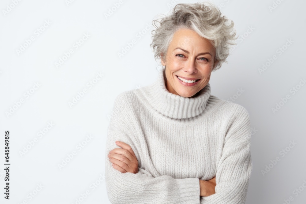 Medium shot portrait photography of a French woman in her 50s wearing a cozy sweater against a white background Medium shot portrait photography of a French woman in her 50s wearing a cozy sweater against a white background