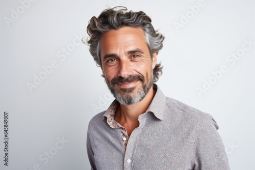 Medium shot portrait photography of a French man in his 40s wearing a foulard against a white background