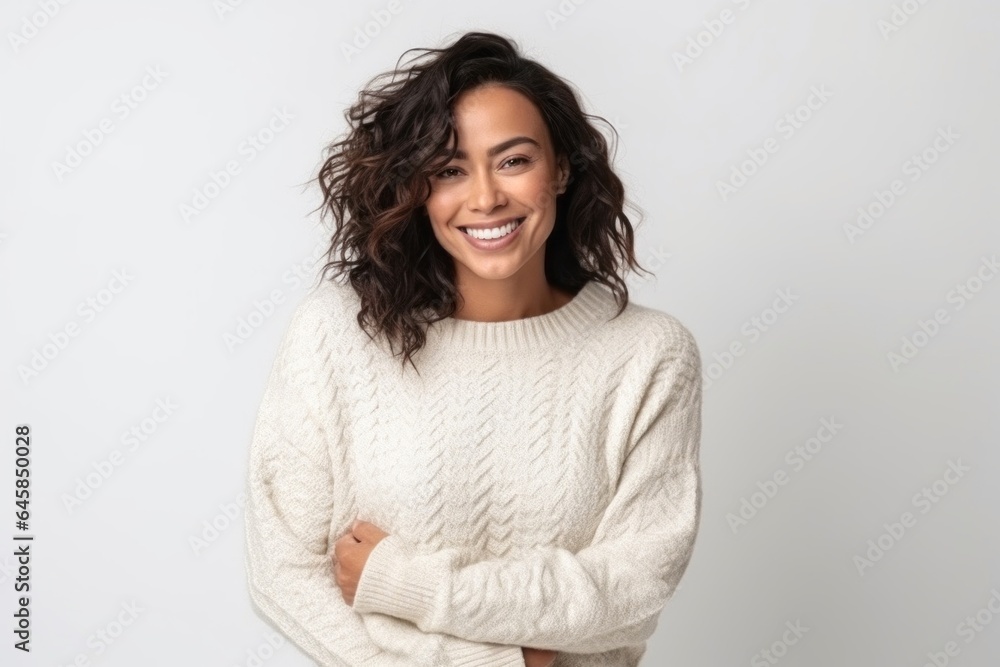 Medium shot portrait photography of a Colombian woman in her 40s wearing a cozy sweater against a white background Medium shot portrait photography of a Colombian woman in her 40s wearing a cozy sweater against a white background