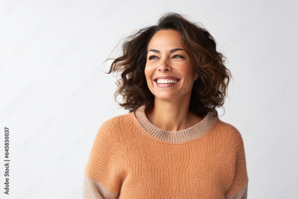 Portrait photography of a Colombian woman in her 40s wearing a cozy sweater against a white background Portrait photography of a Colombian woman in her 40s wearing a cozy sweater against a white background