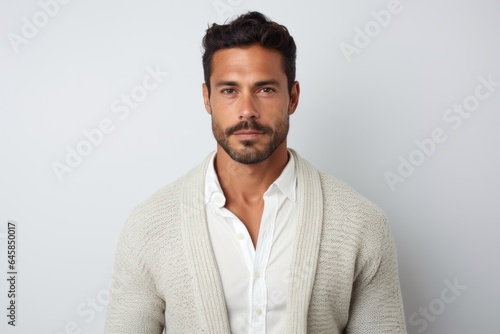 Portrait photography of a serious Colombian man in his 30s against a white background