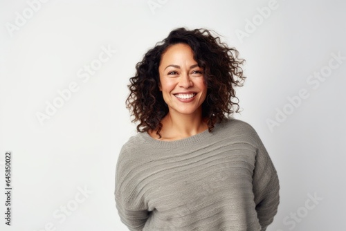 Medium shot portrait photography of a Colombian woman in her 40s wearing a cozy sweater against a white background