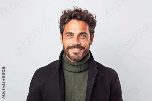 Medium shot portrait photography of a Italian man in his 30s against a white background © Anne Schaum
