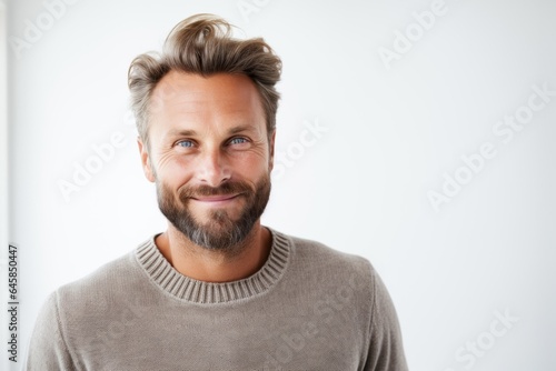 Portrait photography of a Swedish man in his 30s against a white background photo